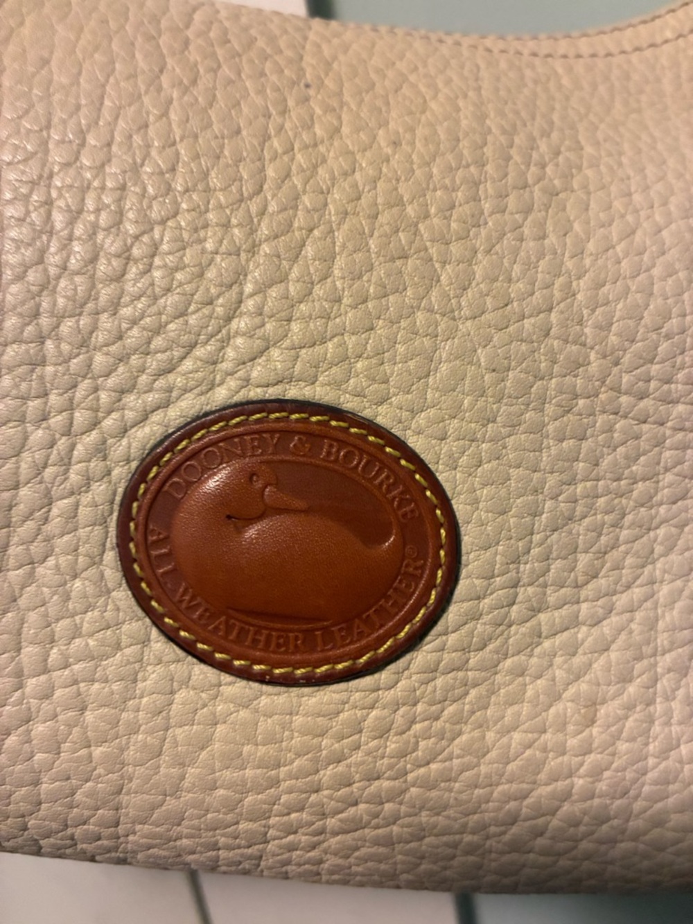 Dooney & Bourke Cream Pebbled Leather Shoulder Bag with Brown Logo Patch